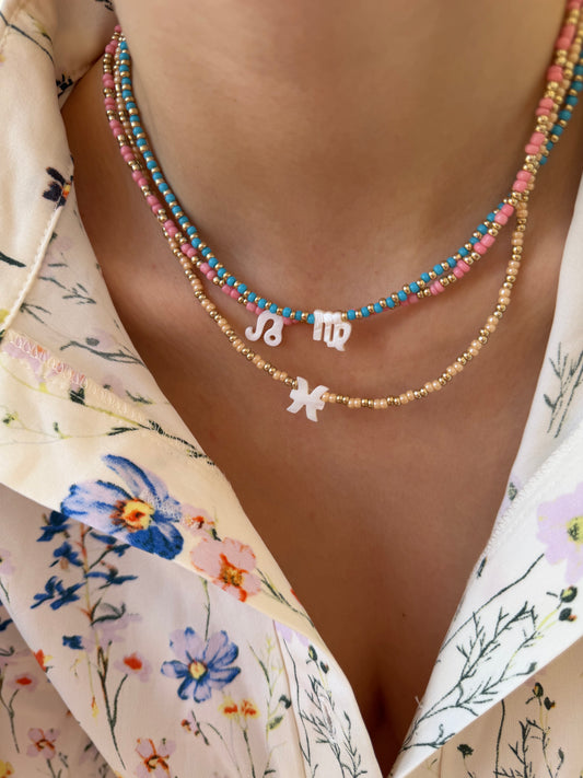 Collana con perline in vetro e segno zodiacale in madreperla