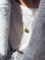 Collana moneta in acciaio dorato