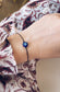 Bracciale con cordoncino e occhio portafortuna