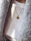 Collana moneta in acciaio dorato