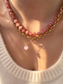 Collana con rondelle in morganite e perline in acciaio dorato