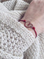 Bracciale con cordoncino e cuore smaltato